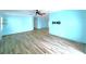 Open living area with light blue walls and wood-look vinyl flooring at 6642 Acacia Ct, North Port, FL 34287