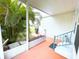 Covered porch with brick planter and view of tropical foliage at 6642 Acacia Ct, North Port, FL 34287