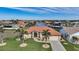 Aerial view of waterfront home with canal access, lush landscaping, and nearby residences at 720 Bimini Ln, Punta Gorda, FL 33950