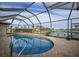 Inviting kidney-shaped pool with screened enclosure and water view at 720 Bimini Ln, Punta Gorda, FL 33950