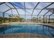 Relaxing pool area with a screened enclosure and water views at 720 Bimini Ln, Punta Gorda, FL 33950