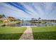 Landscaped backyard with a paved walkway leading to the waterfront at 720 Bimini Ln, Punta Gorda, FL 33950