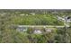 Aerial view of three houses, one with a pool at 813 Thornton Nw Ave, Port Charlotte, FL 33948