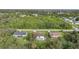 Aerial view of three houses, one with a pool at 813 Thornton Nw Ave, Port Charlotte, FL 33948