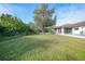 Backyard with grassy area, large tree, and pool at 813 Thornton Nw Ave, Port Charlotte, FL 33948