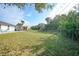 Large backyard with grassy area and chain link fence at 813 Thornton Nw Ave, Port Charlotte, FL 33948