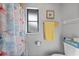 Bathroom with shower, window, and beachy decor at 813 Thornton Nw Ave, Port Charlotte, FL 33948