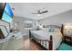 Main bedroom with king-size bed, ceiling fan, and wood floors at 813 Thornton Nw Ave, Port Charlotte, FL 33948