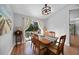 Bright dining room with wooden table and chairs, near sliding doors to backyard at 813 Thornton Nw Ave, Port Charlotte, FL 33948