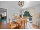 Bright dining room with wooden table and chairs, view to the pool at 813 Thornton Nw Ave, Port Charlotte, FL 33948