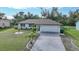 Single story home with attached garage and landscaped lawn at 813 Thornton Nw Ave, Port Charlotte, FL 33948