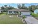 Single story home with attached garage and landscaped lawn at 813 Thornton Nw Ave, Port Charlotte, FL 33948