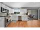 Modern kitchen with white cabinets, stainless steel appliances, and mosaic backsplash at 813 Thornton Nw Ave, Port Charlotte, FL 33948