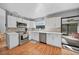 Modern kitchen with white cabinets, stainless steel appliances, and mosaic backsplash at 813 Thornton Nw Ave, Port Charlotte, FL 33948