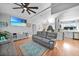 Spacious living room with gray reclining sofas and wood floors at 813 Thornton Nw Ave, Port Charlotte, FL 33948