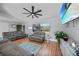 Bright living room featuring gray sofas and a large TV at 813 Thornton Nw Ave, Port Charlotte, FL 33948