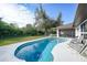 Refreshing kidney-shaped pool with patio and backyard view at 813 Thornton Nw Ave, Port Charlotte, FL 33948