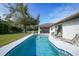 Relaxing kidney-shaped pool with patio and backyard view at 813 Thornton Nw Ave, Port Charlotte, FL 33948