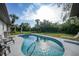 Relaxing kidney-shaped pool with lounge chairs at 813 Thornton Nw Ave, Port Charlotte, FL 33948