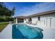 Kidney-shaped pool with surrounding patio and lounge chairs at 813 Thornton Nw Ave, Port Charlotte, FL 33948