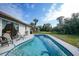 Relaxing kidney-shaped pool with patio and backyard access at 813 Thornton Nw Ave, Port Charlotte, FL 33948