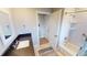 Updated bathroom with dark vanity, white tile, and tub at 1022 Lucia Dr, Punta Gorda, FL 33950