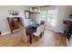 Charming dining room with hardwood floors, a dark wood table, and a view into the kitchen at 1022 Lucia Dr, Punta Gorda, FL 33950