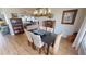 Spacious dining room with hardwood floors, a dark wood table, and views of living and kitchen areas at 1022 Lucia Dr, Punta Gorda, FL 33950