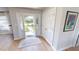 Light and airy entryway with hardwood floors, neutral colors, and access to a hallway at 1022 Lucia Dr, Punta Gorda, FL 33950