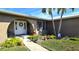 Attractive landscaping, walkway, and a white front door with a wreath at 1022 Lucia Dr, Punta Gorda, FL 33950