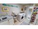Laundry room with washer, dryer, storage, and utility sink at 1022 Lucia Dr, Punta Gorda, FL 33950