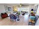 Comfortable living space featuring hardwood floors, a neutral color palette, and access to a waterfront patio at 1022 Lucia Dr, Punta Gorda, FL 33950