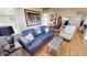 Living area features a blue sofa and hardwood floors at 1022 Lucia Dr, Punta Gorda, FL 33950