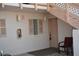 Condo entrance with a door, a chair, and a fire extinguisher at 1051 Forrest Nelson Blvd # A-104, Port Charlotte, FL 33952