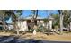 Front view of condo building showcasing landscaping and a tree-lined street at 1051 Forrest Nelson Blvd # A-104, Port Charlotte, FL 33952
