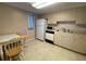 Efficient kitchen with white appliances and dining area at 1051 Forrest Nelson Blvd # A-104, Port Charlotte, FL 33952