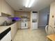 Compact kitchen featuring a full-size refrigerator and stackable washer/dryer at 1051 Forrest Nelson Blvd # A-104, Port Charlotte, FL 33952