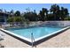Community pool with lounge chairs and umbrellas at 1051 Forrest Nelson Blvd # A-104, Port Charlotte, FL 33952