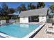 Community pool with lounge chairs and tables at 1051 Forrest Nelson Blvd # A-104, Port Charlotte, FL 33952