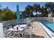 Enjoy relaxing poolside with tables and umbrellas at 1051 Forrest Nelson Blvd # A-104, Port Charlotte, FL 33952