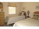 Two twin beds, wicker headboard, dresser, and window with blinds at 1246 Rio De Janeiro Ave # 503, Punta Gorda, FL 33983