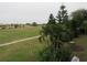 Residential community view of green golf course, palm trees, and condo buildings at 1246 Rio De Janeiro Ave # 503, Punta Gorda, FL 33983