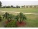 Community view of green golf course with palm trees and residential buildings in the background at 1246 Rio De Janeiro Ave # 503, Punta Gorda, FL 33983