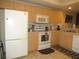 Bright kitchen boasts ample counter space and white appliances at 1246 Rio De Janeiro Ave # 503, Punta Gorda, FL 33983