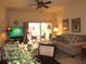 Living room with sofa, TV, and access to balcony at 1246 Rio De Janeiro Ave # 503, Punta Gorda, FL 33983