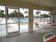Community pool area with patio furniture, screened enclosure at 1246 Rio De Janeiro Ave # 503, Punta Gorda, FL 33983