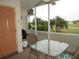 Screened porch with table and chairs, golf course view at 1246 Rio De Janeiro Ave # 503, Punta Gorda, FL 33983