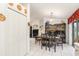 Dining room with black table and chairs, white cabinets, and access to patio at 1264 Shadow Ln, North Port, FL 34286