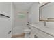 Clean bathroom with white vanity, bathtub, and tiled shower at 1325 Goshen Rd, North Port, FL 34288
