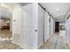 Inviting hallway with barn doors and light neutral color palette at 136 Creek Se Dr, Port Charlotte, FL 33952